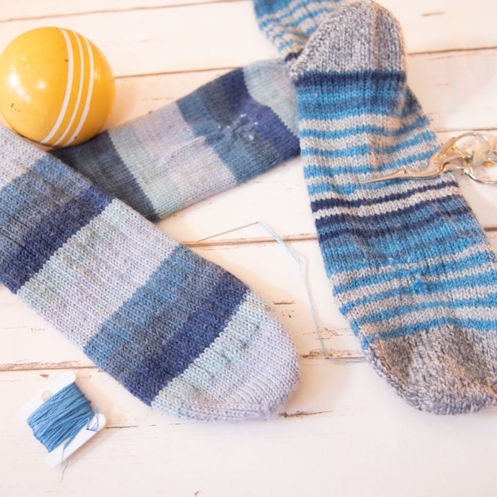 darned socks, embroidery floss, needle, croquet ball